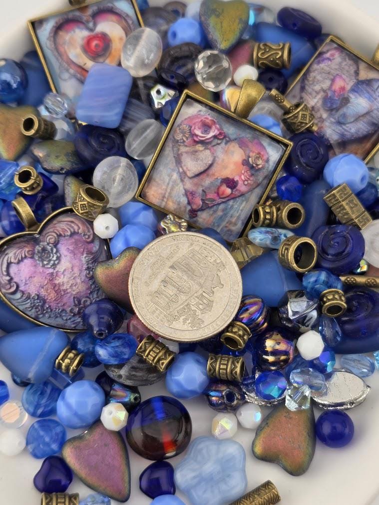 The image is a collage of various colorful beads, charms, and coins, creating a visually appealing and diverse arrangement.