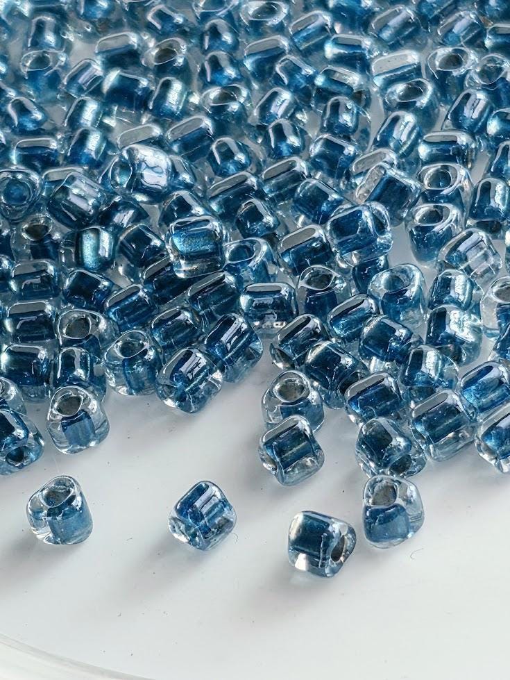 Crystal/Dk Turq Blue Inside Color Lined Sparkle Miyuki Triangle Size 8/0 (15g Pkg)