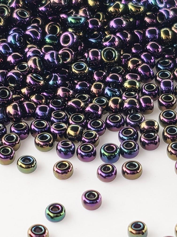 a collection of multicolored glass beads scattered across a white background.
