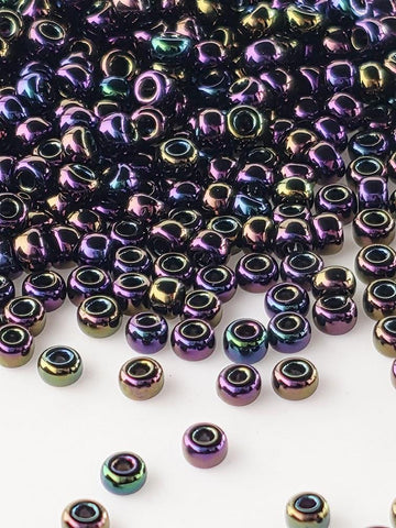a collection of multicolored glass beads scattered across a white background.