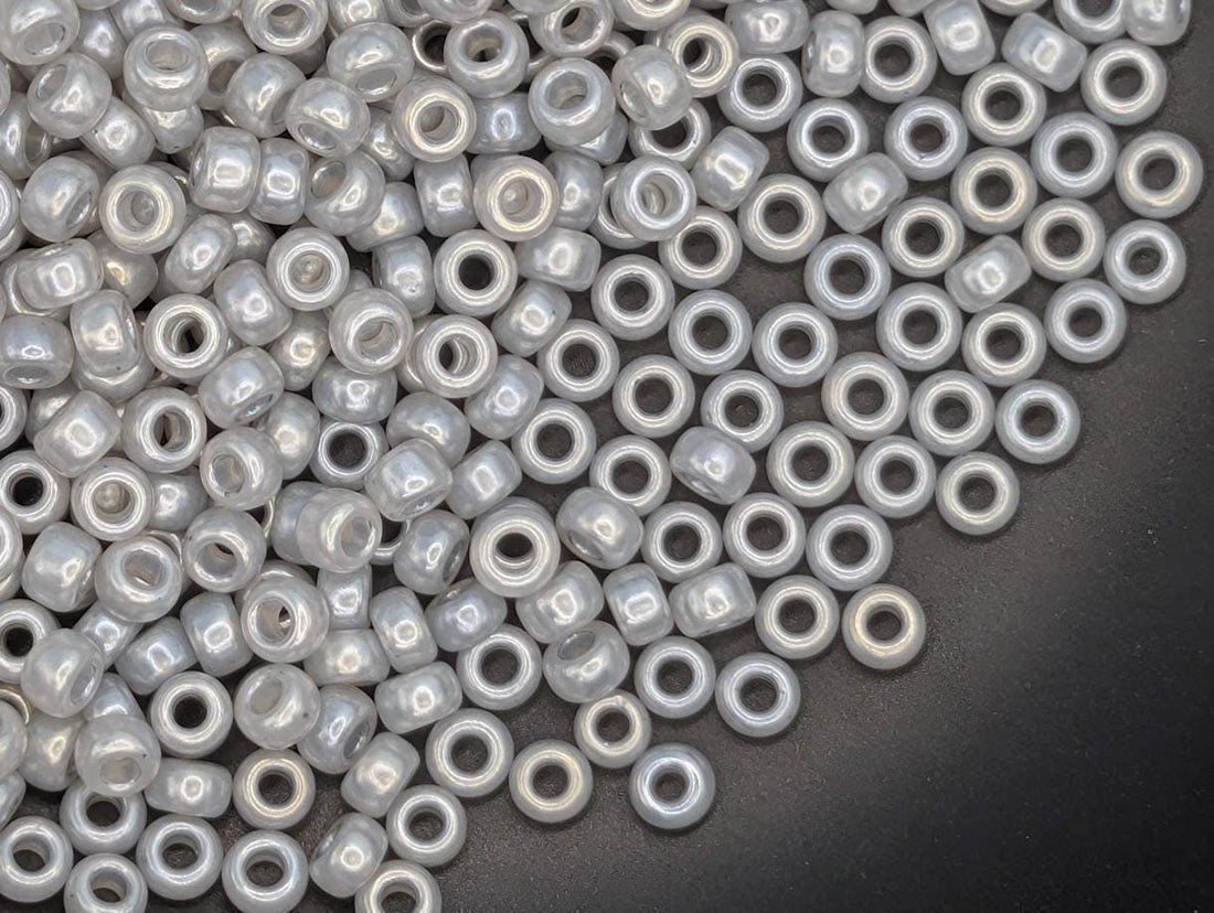 a large pile of small, clear beads scattered across a surface.