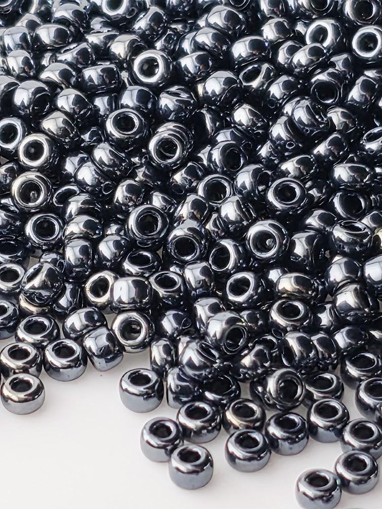 a large pile of small, shiny, metallic beads scattered across a surface.
