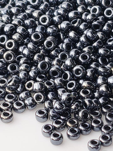 a large pile of small, shiny, metallic beads scattered across a surface.