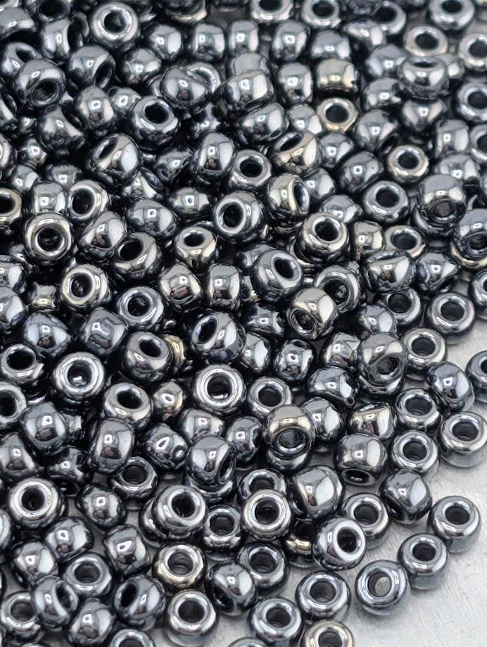 a large pile of small, shiny, metallic beads scattered across a surface.