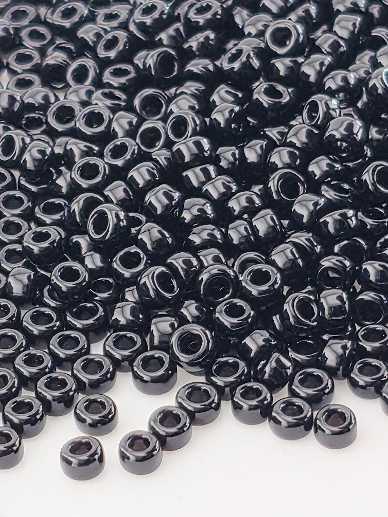 a large pile of black beads or beads, with some scattered around the edges of the frame.