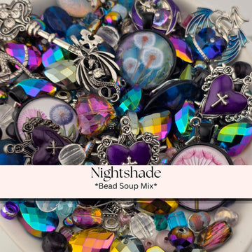 A colorful assortment of beads, charms, and other decorative items, including heart-shaped charms, gemstones, and glass beads, arranged in a visually appealing manner.
