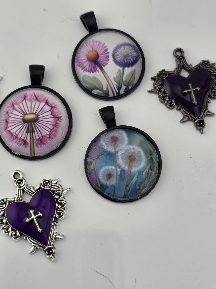 A colorful assortment of beads, charms, and other decorative items, including heart-shaped charms, gemstones, and glass beads, arranged in a visually appealing manner.
