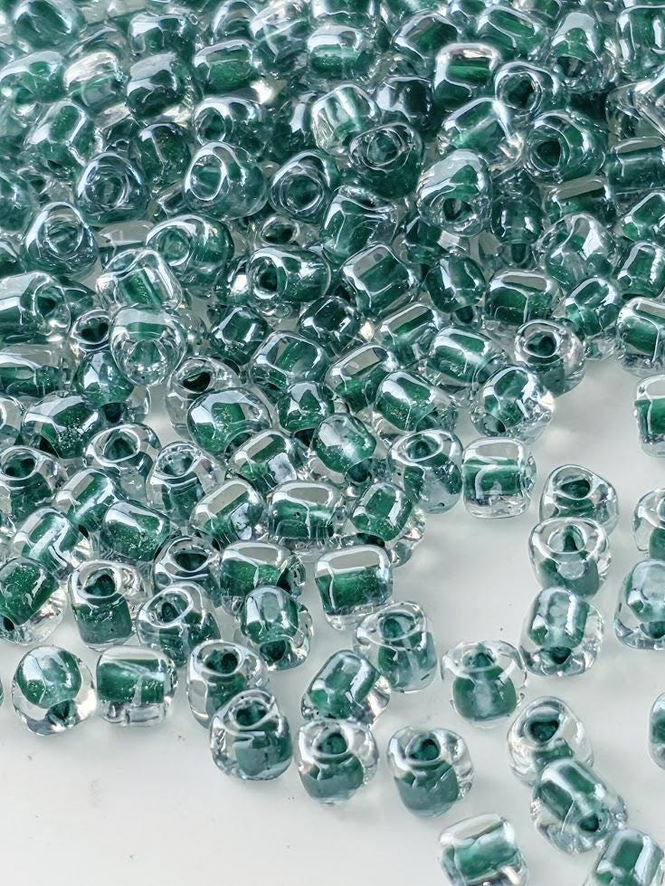 Crystal/Hunter Green Inside Color Lined Sparkle Miyuki Triangle Size 8/0 (15g Pkg)