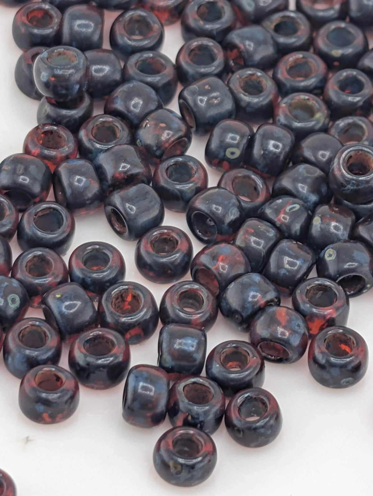 Toho Japanese Seed Beads: Hybrid Frosted Siam Ruby Picasso , 6/0 | Round Glass | 2.5" Tube