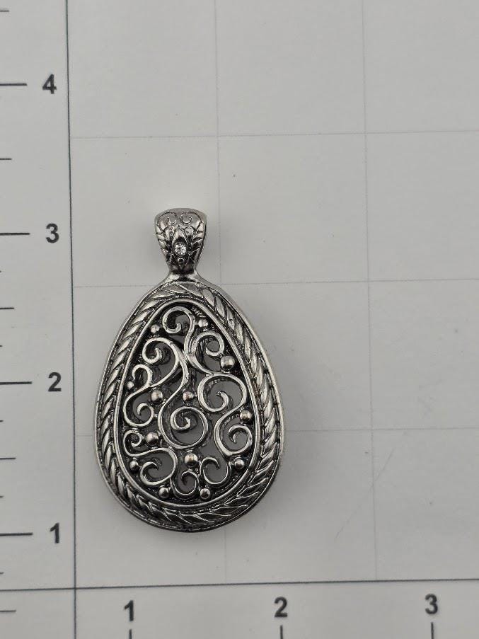 a pendant with an intricate, decorative design.