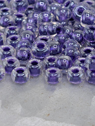 Crystal/Dark Purple Inside Color Lined Rocaille | 6/0 | Miyuki - 15g pkg