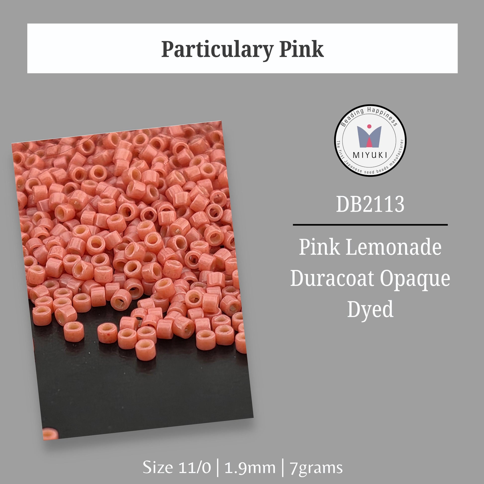 a pile of pink beads, specifically beads that have been dyed, and there is a logo or emblem in the top right corner.