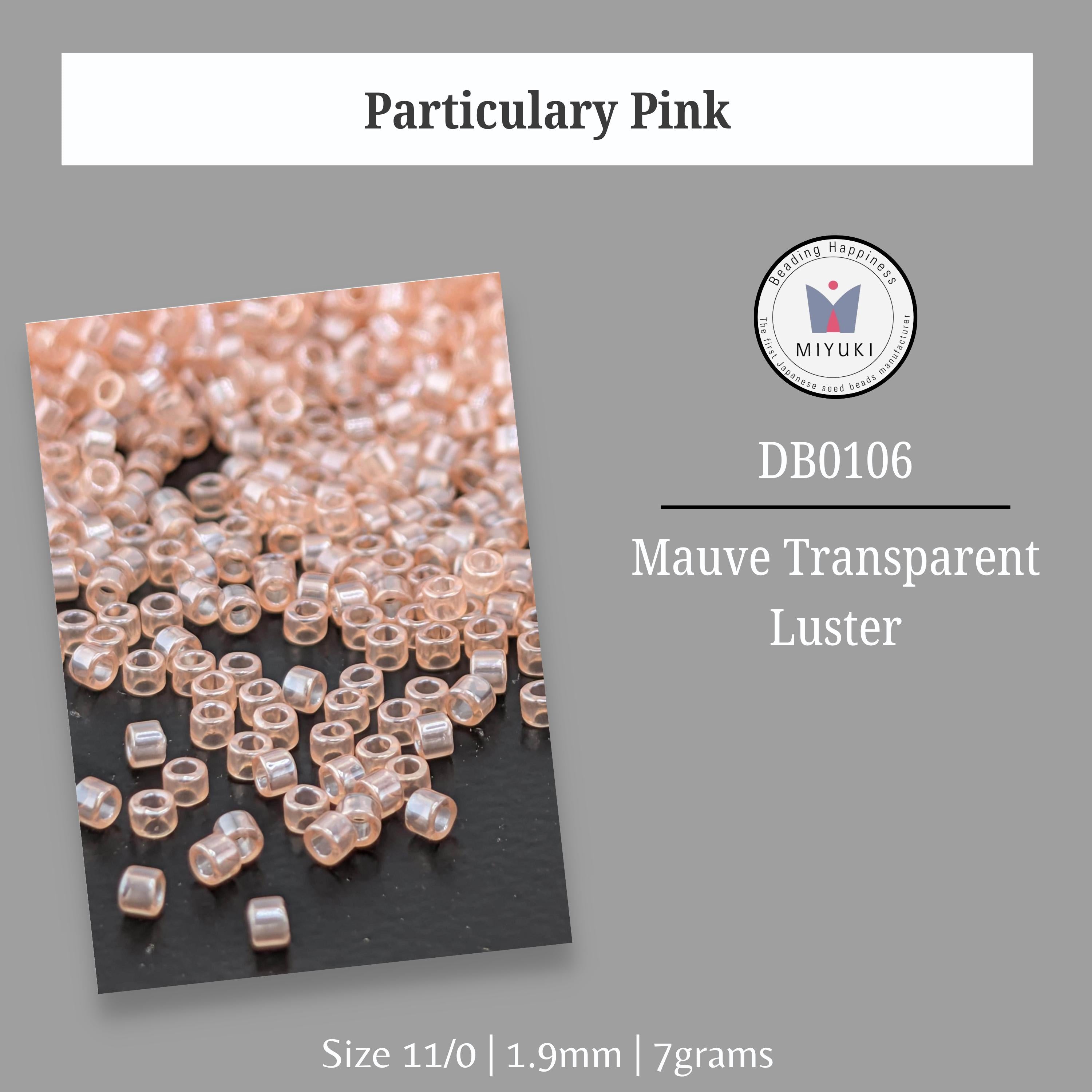 a collection of small, clear beads in various shades of pink, arranged on a black background.