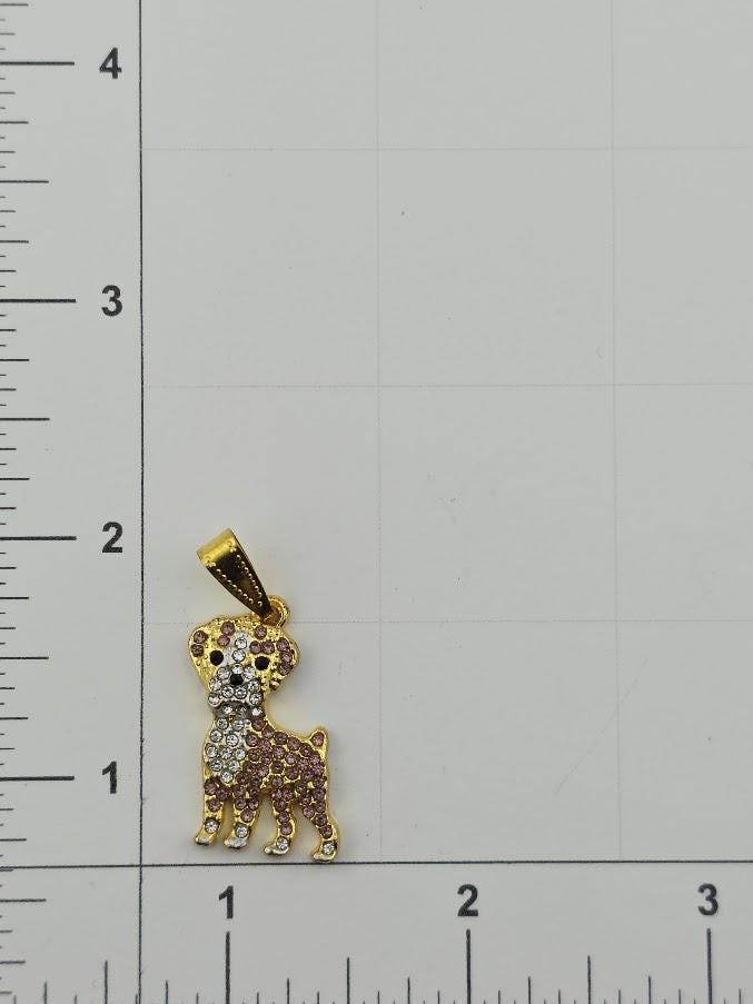 A small gold-colored pendant in the shape of a dog is shown, with a diamond-encrusted design.