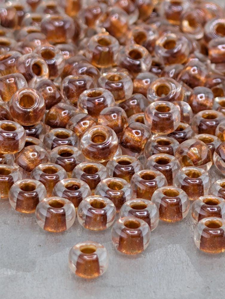 6-1551:Crystal/Burnt Orange ICL*-Miyuki Rocaille 6/0 (20g pkg ~240 pcs)