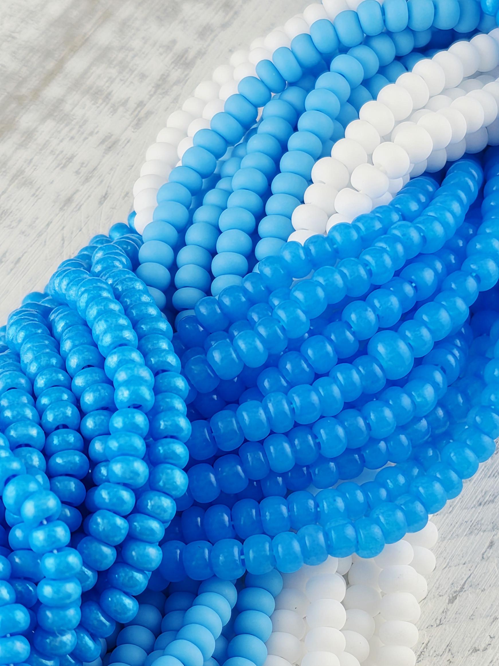 A close-up image of a collection of blue and white beads arranged in a visually appealing manner.
