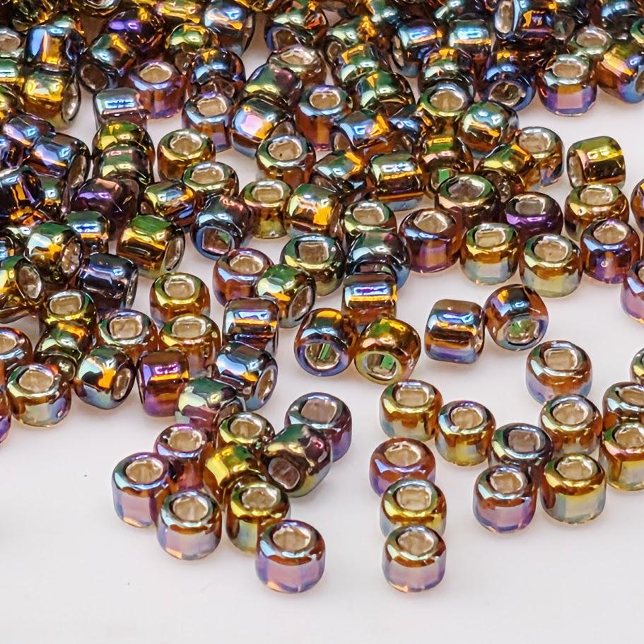a collection of multicolored beads scattered across a white background.
