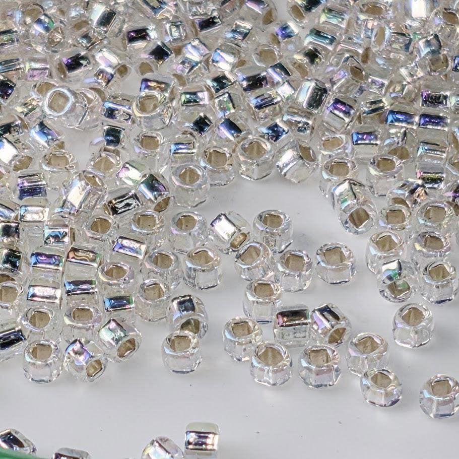 numerous small, clear beads scattered across a surface.