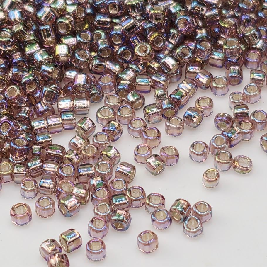 a collection of small, multicolored beads scattered across a white background.