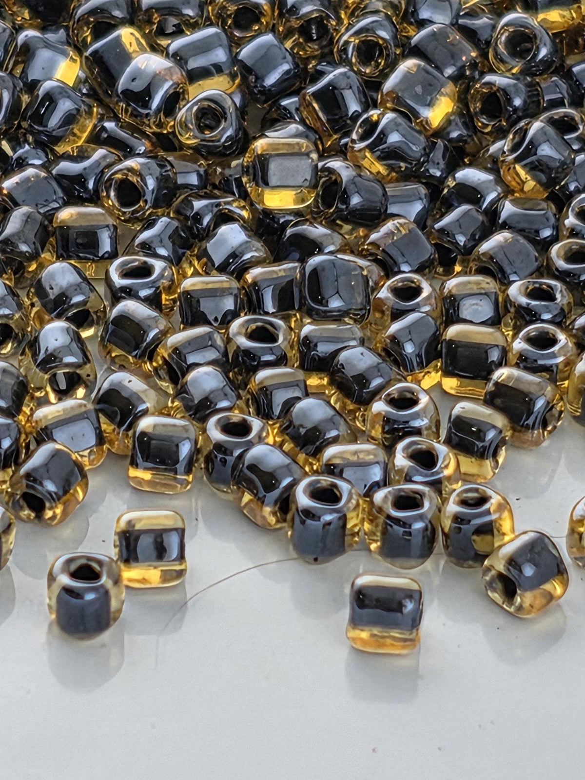 Amber/Black Inside Color Lined Miyuki Triangle Size 10/0 (15g Pkg)
