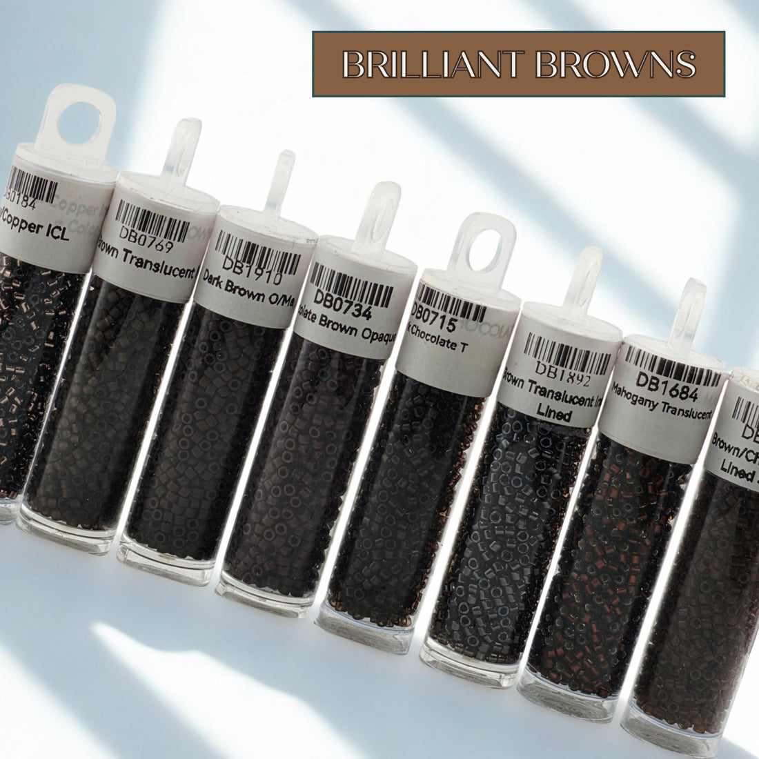 A collection of eight black beads in various sizes and shapes, each with a label indicating the color and type of bead.