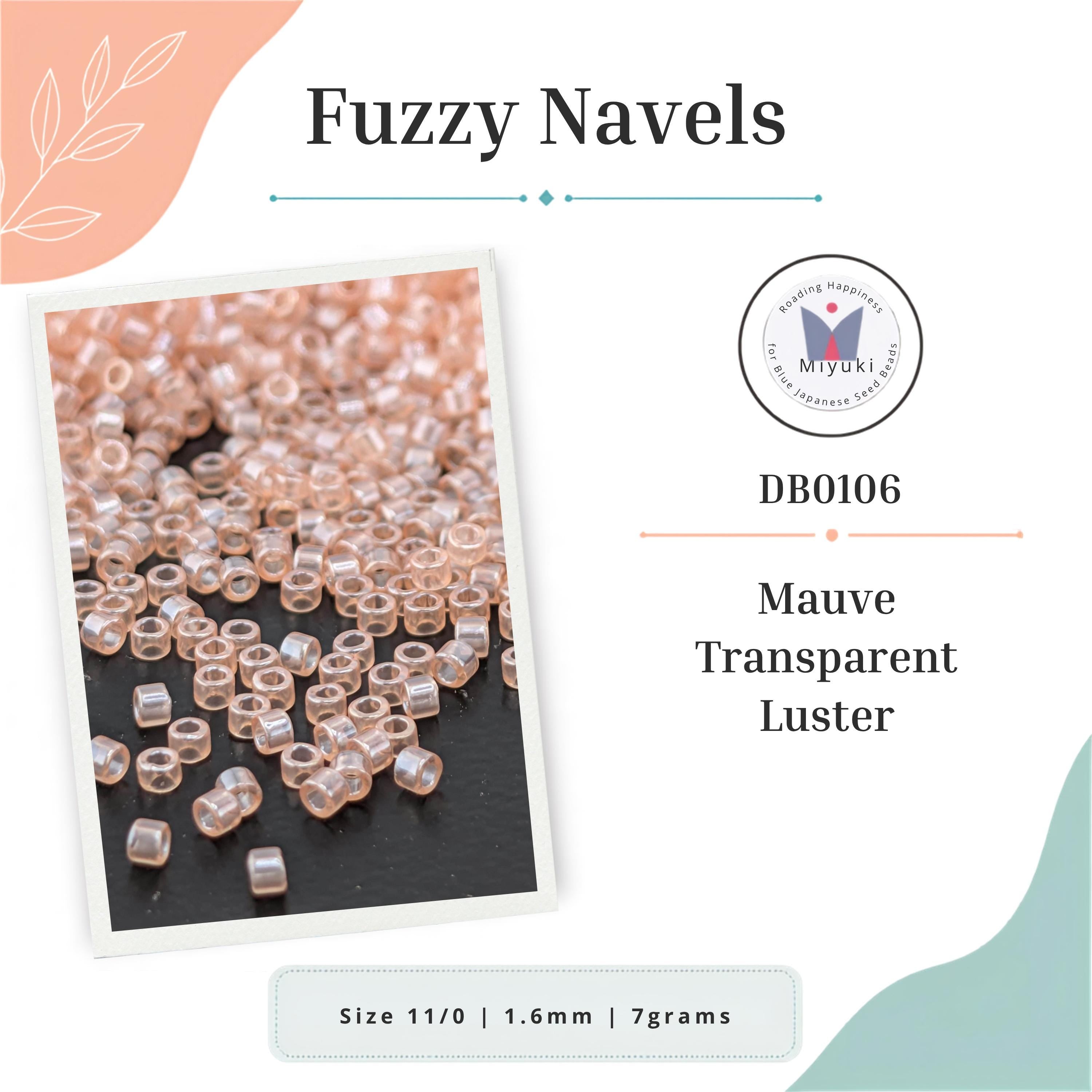 a close-up of numerous small, clear beads or navels arranged on a dark surface.