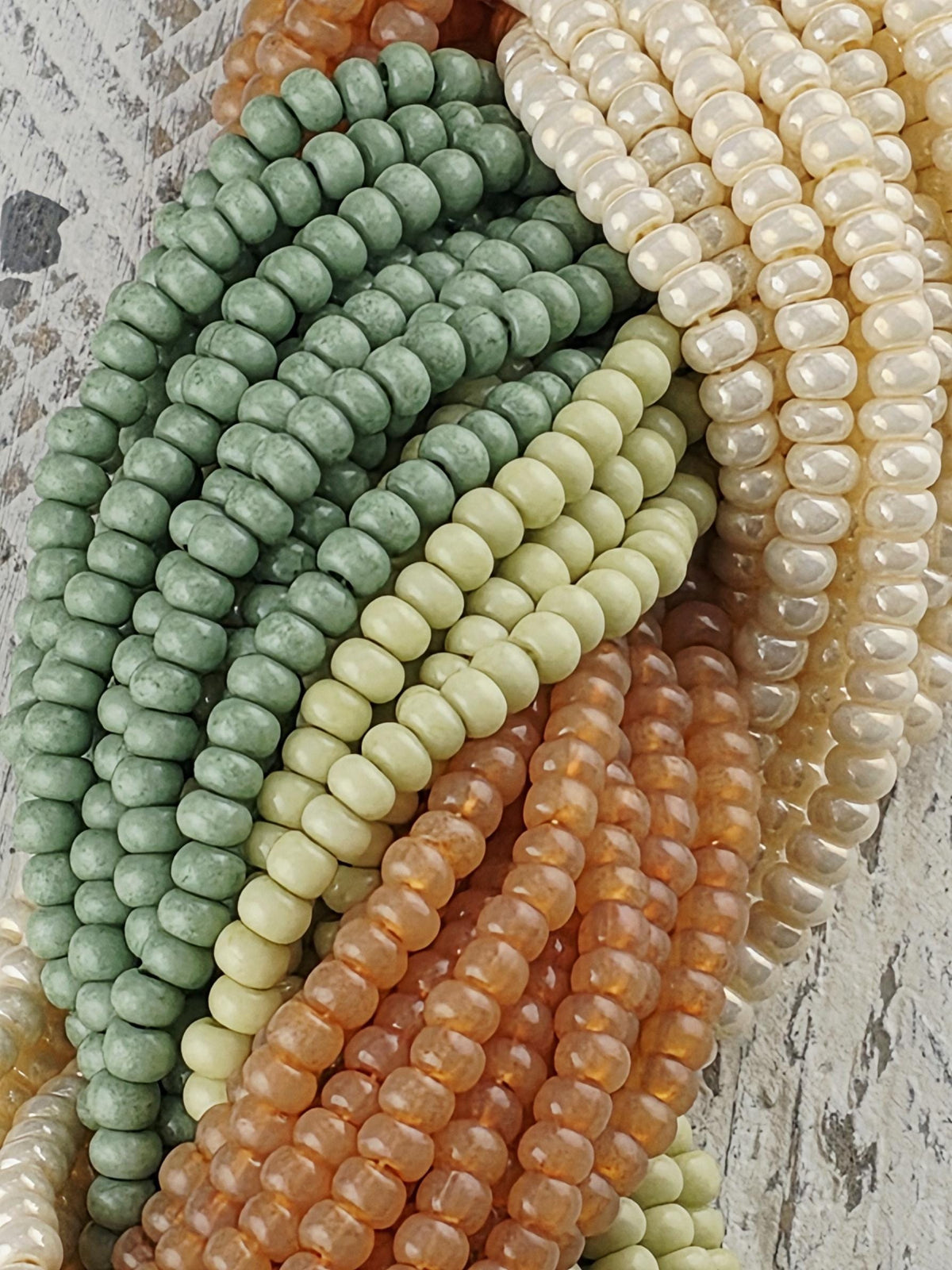 A collection of colorful beads, including white, green, orange, and yellow beads, arranged in a visually appealing manner.