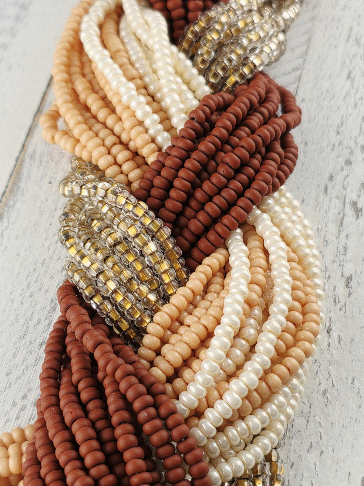 A collection of colorful beads, including white, brown, and beige beads, arranged in a visually appealing manner.