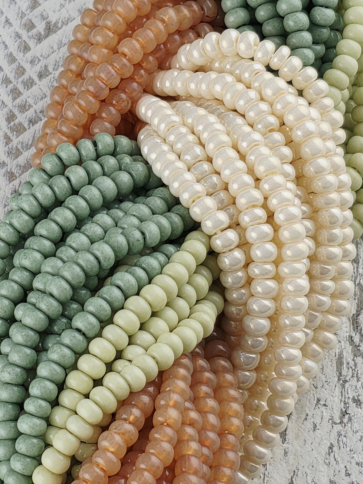 A collection of colorful beads, including white, green, orange, and brown beads, arranged in a visually appealing manner.