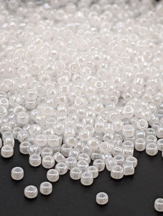 a large pile of clear, white beads scattered on a dark background.
