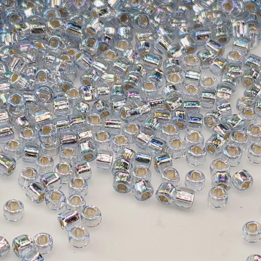 numerous small, clear beads scattered across a surface.