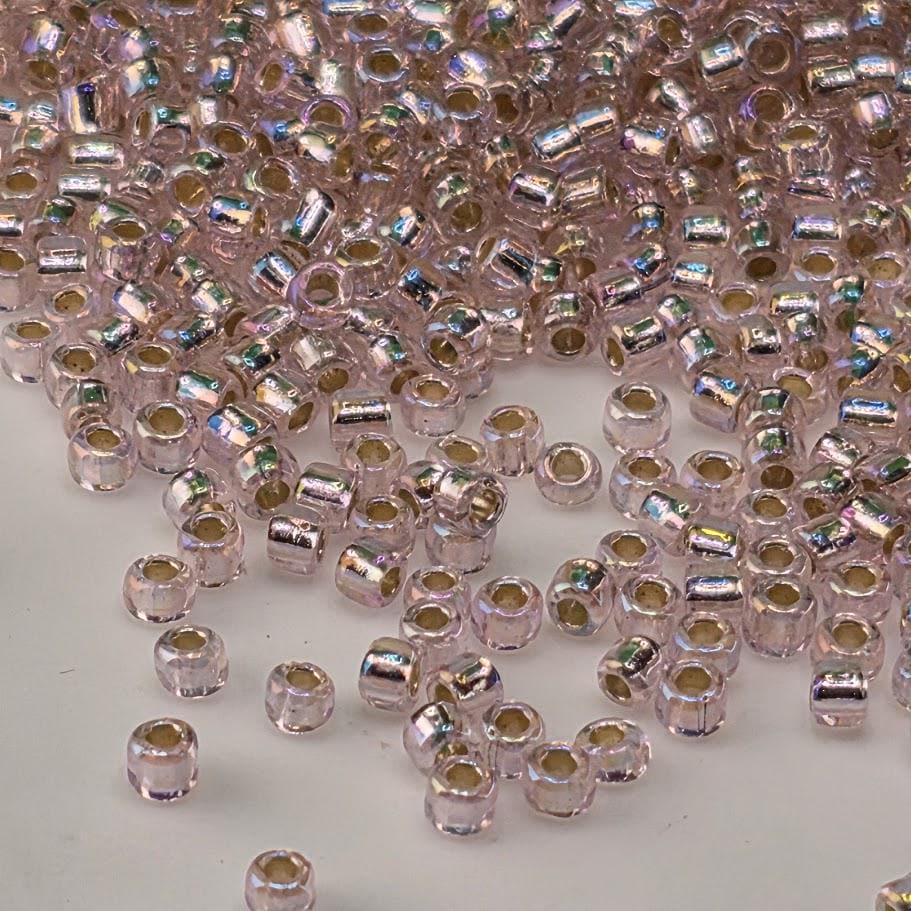 a large number of small, clear beads scattered across a surface.