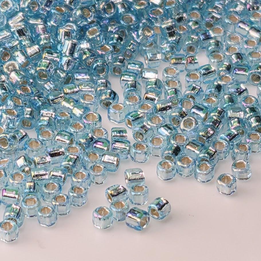 a large number of small, clear beads scattered across a surface.