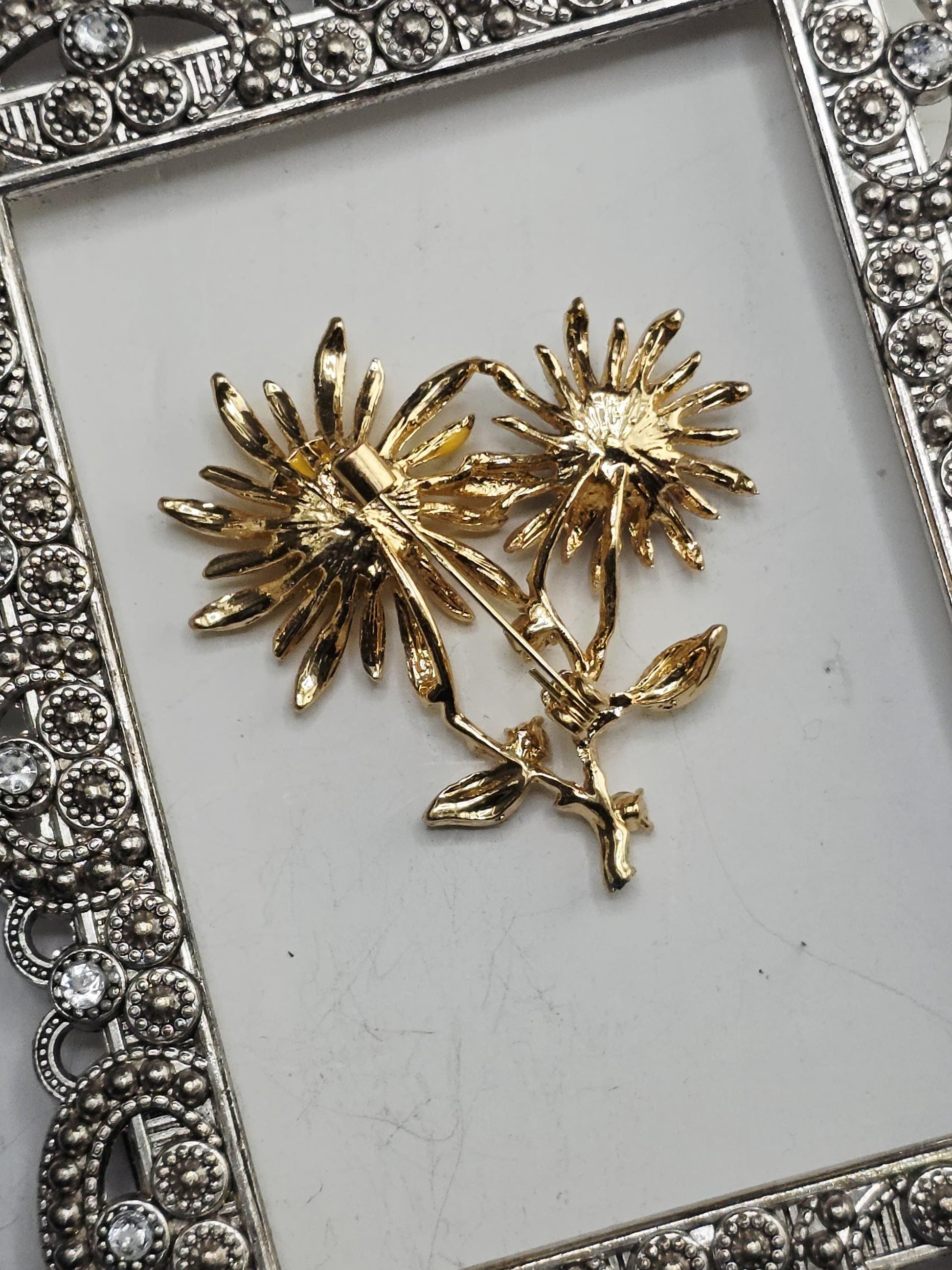 A decorative metal frame with a floral design on a white background.