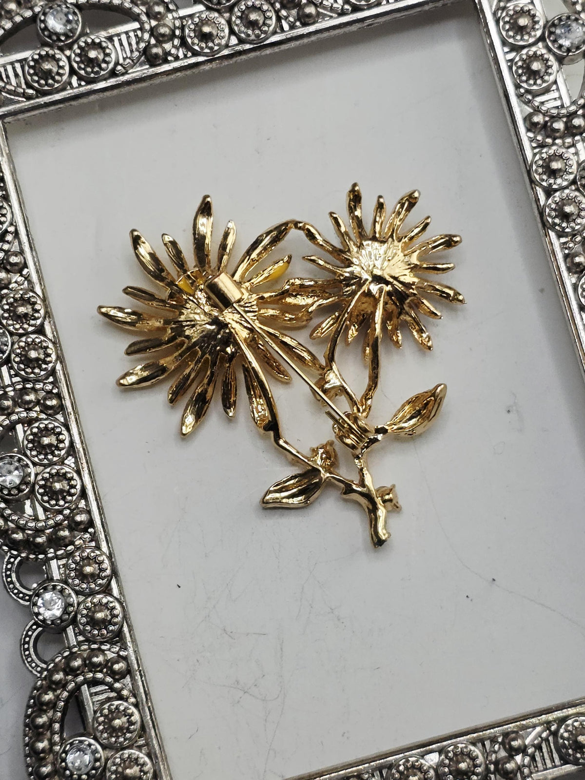 A decorative metal frame with a floral design on a white background.