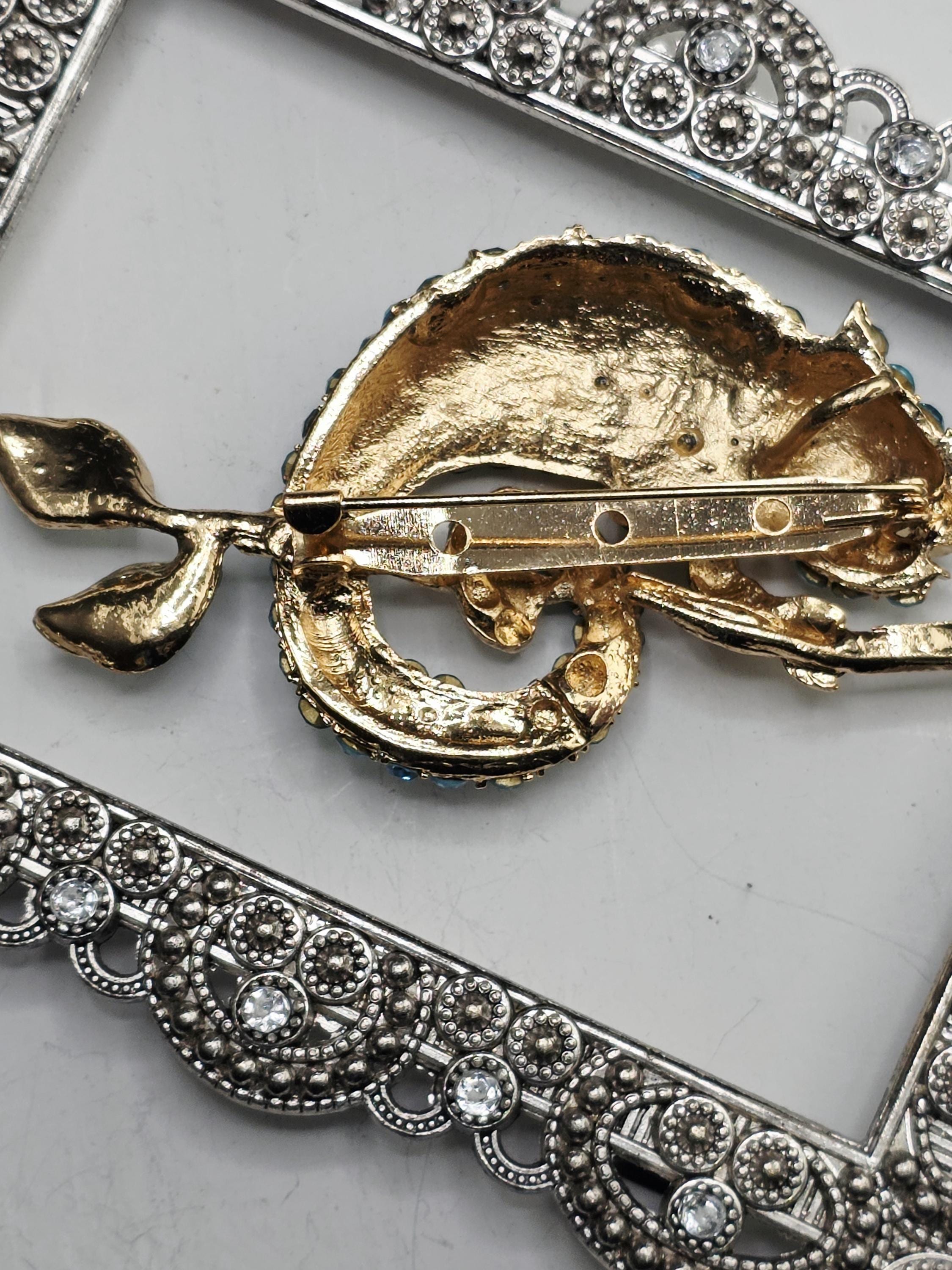 a decorative piece with a gold-colored metal frame and a floral design.