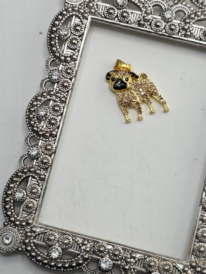 A decorative silver frame with a gold pug charm in the center.