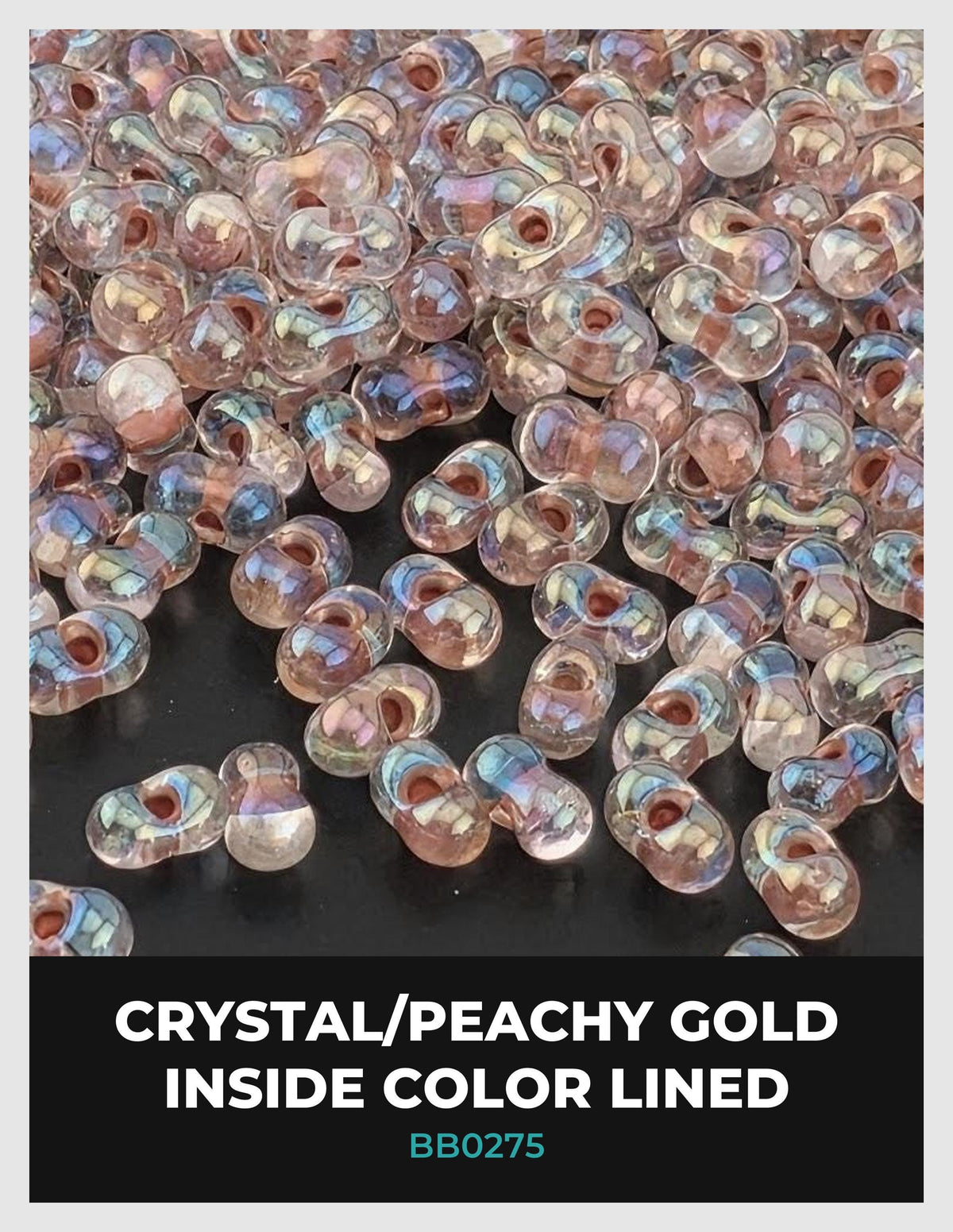 a collection of clear, iridescent beads in various colors, including shades of pink, blue, and green, scattered across a dark background.