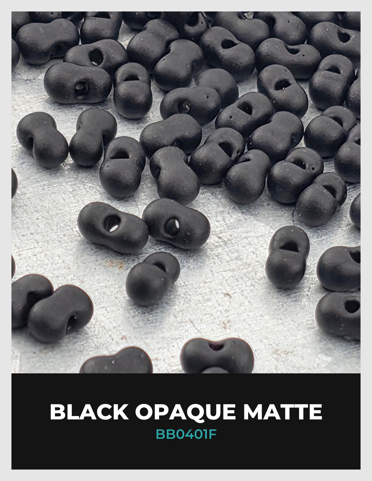 a collection of black beads or buttons scattered on a white surface.