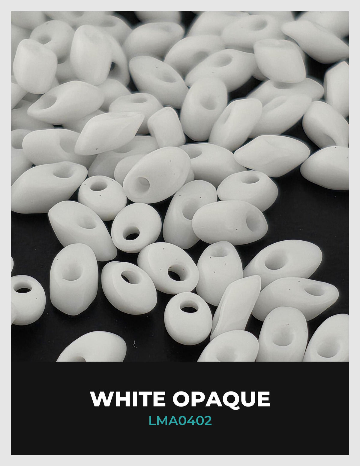 The image is a close-up of numerous white, oval-shaped beads scattered on a dark background.