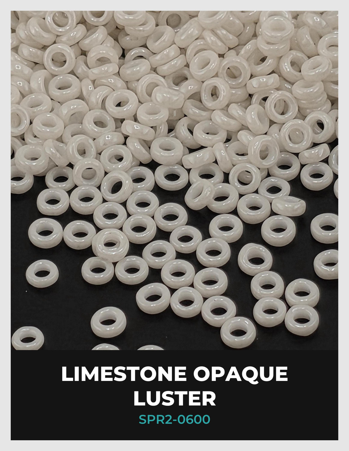 a pile of white, round beads scattered on a black background.