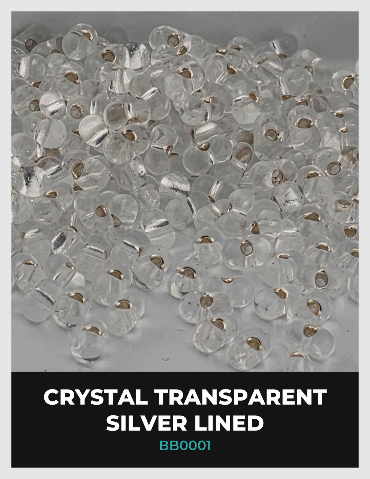 The image is a close-up of numerous transparent crystal beads, with a focus on their silver lining.