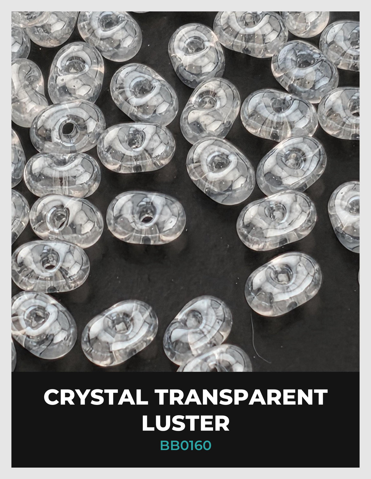 a collection of clear, transparent beads scattered across a dark background.