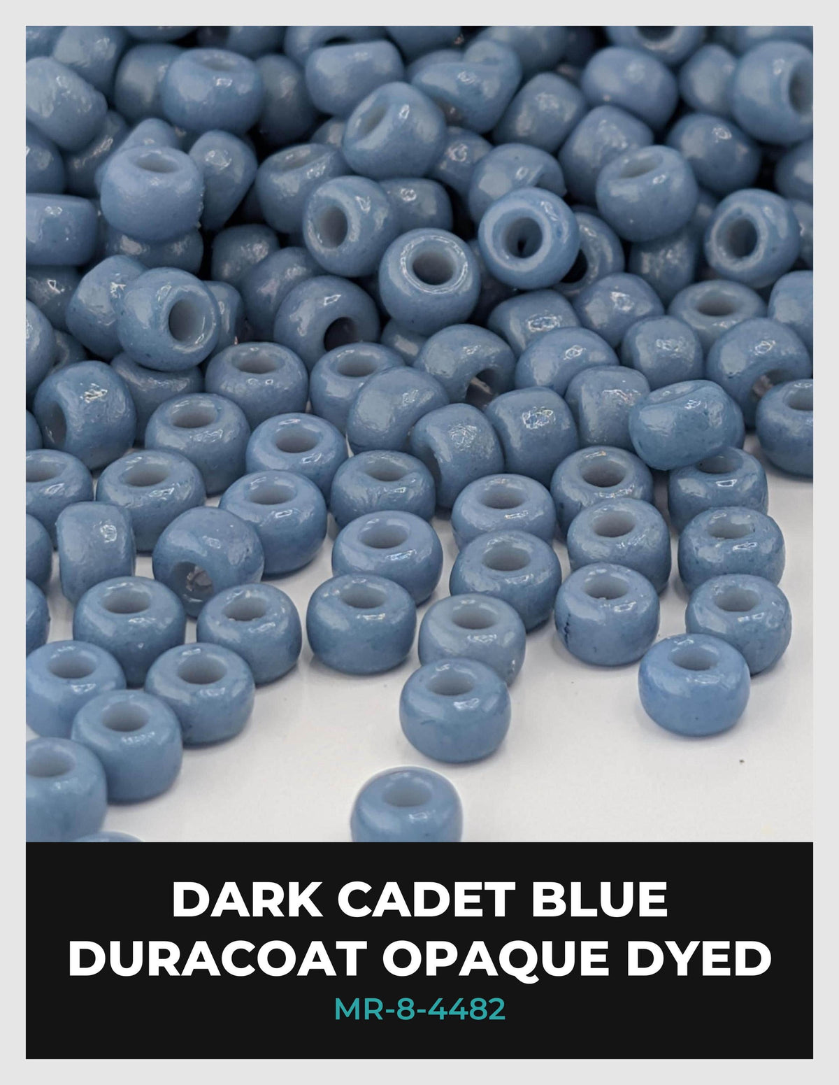 a large pile of small, round, blue beads on a white background.