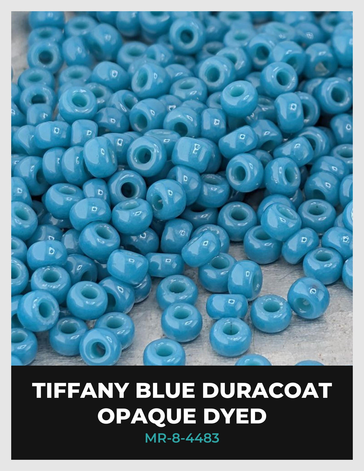 a large pile of blue beads, possibly made of glass or plastic, scattered on a surface.