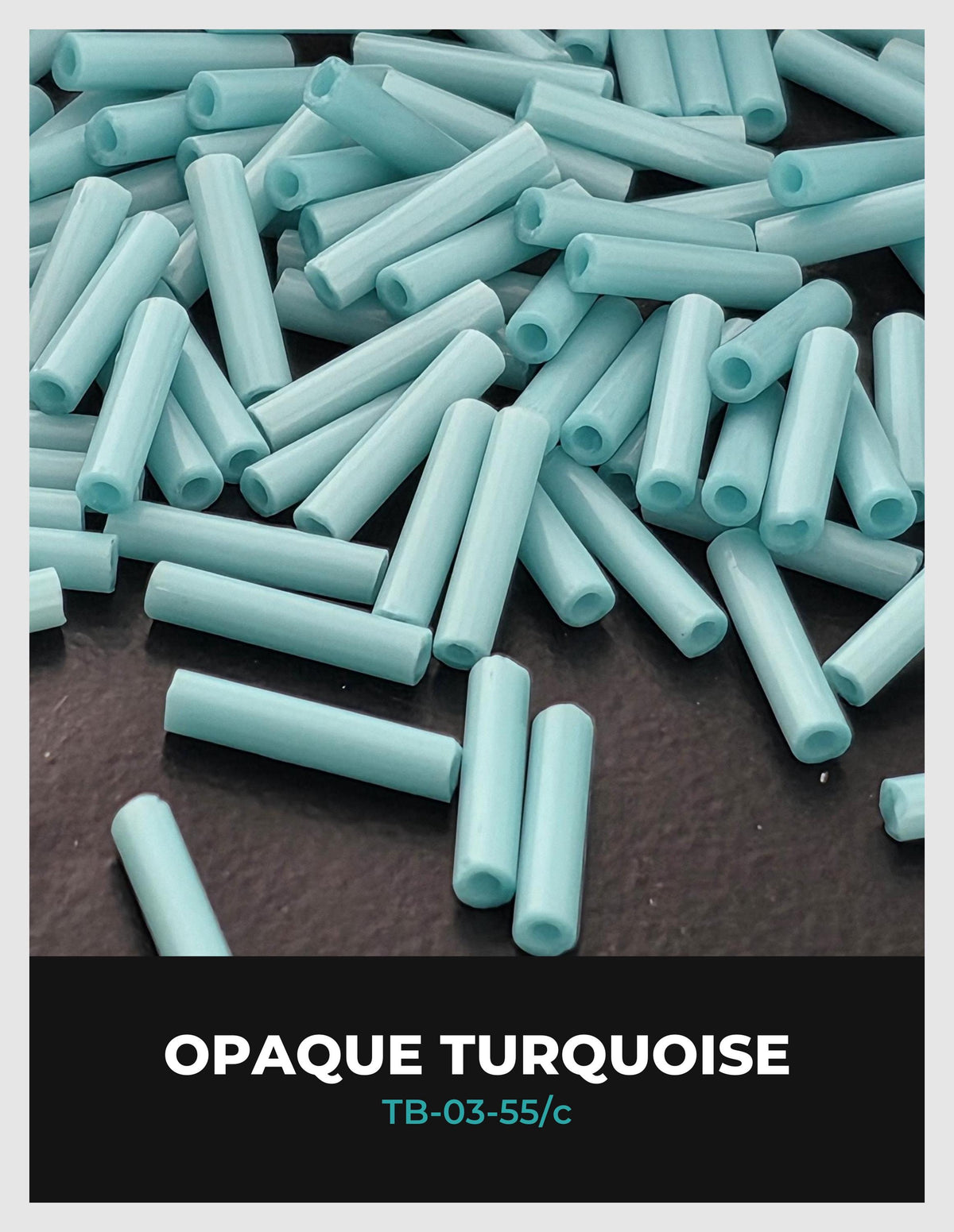 a pile of turquoise-colored tubes or rods on a dark surface.