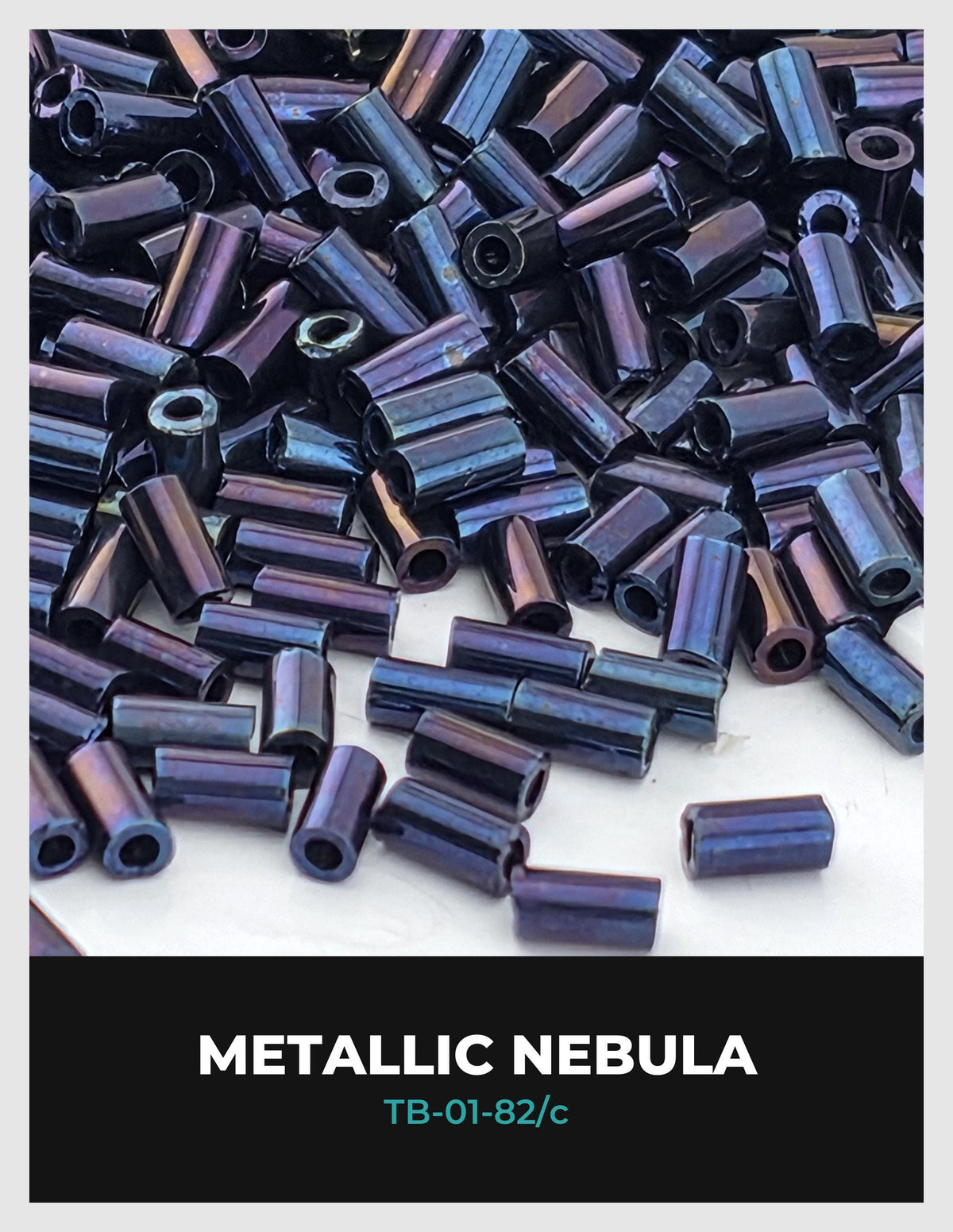 The image is a close-up of numerous metallic beads in shades of blue and purple, scattered across a surface.