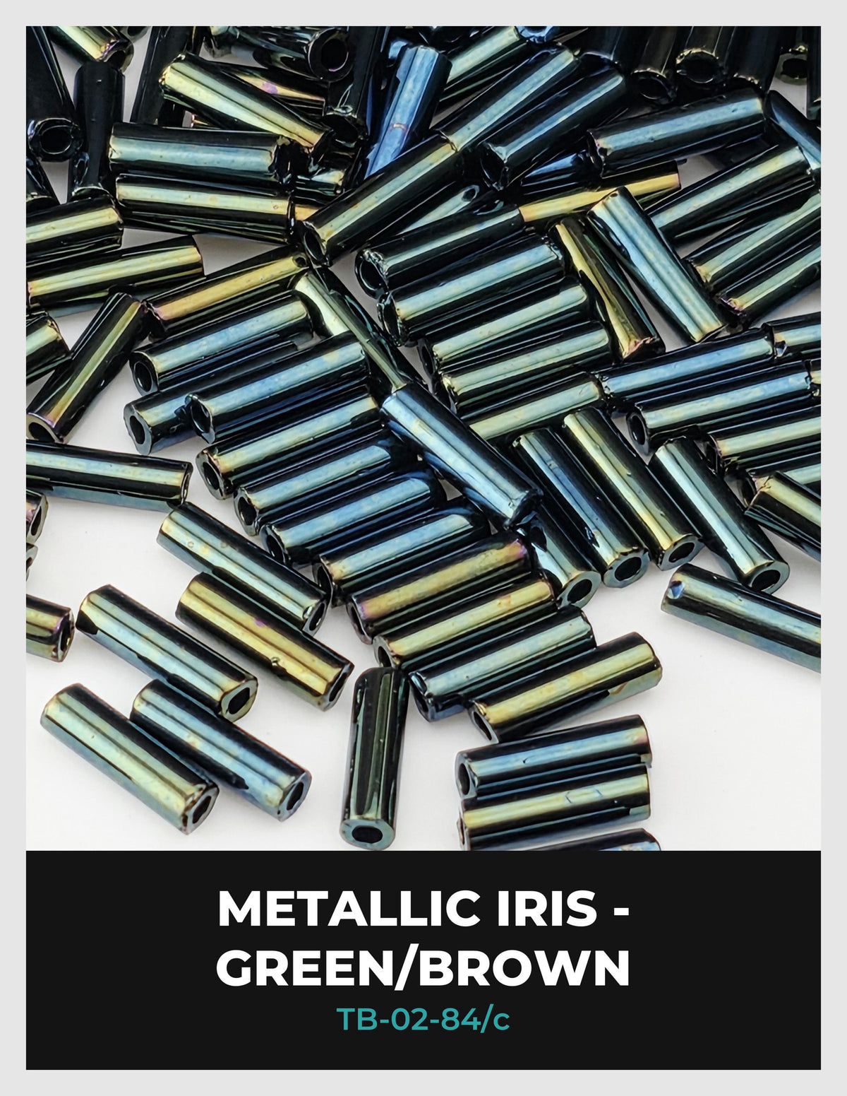 The image is a close-up of numerous metallic beads in various colors, including green, brown, and blue, scattered across a surface.