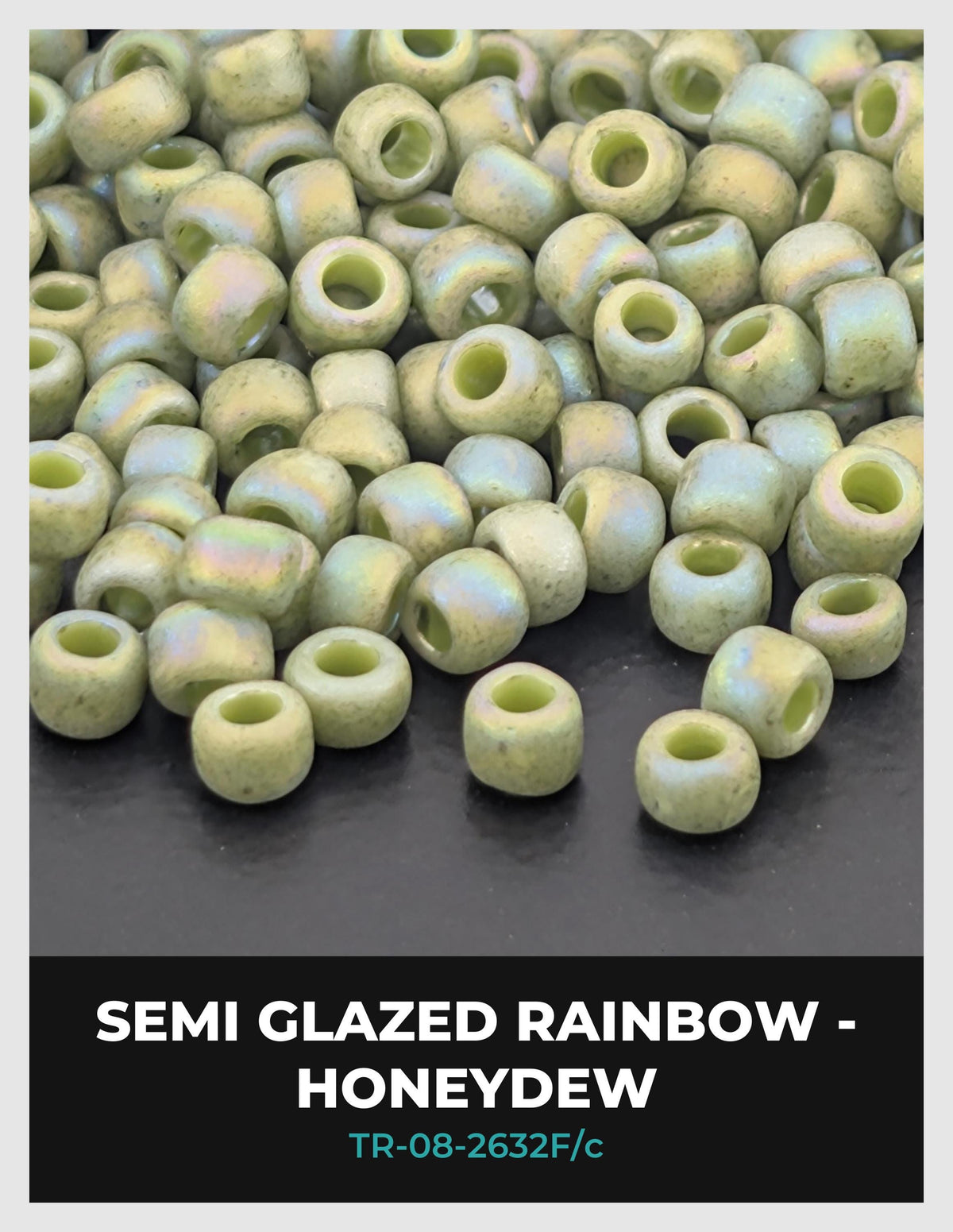a pile of semi-glazed rainbow-colored beads, specifically honeydew beads, arranged on a dark surface.