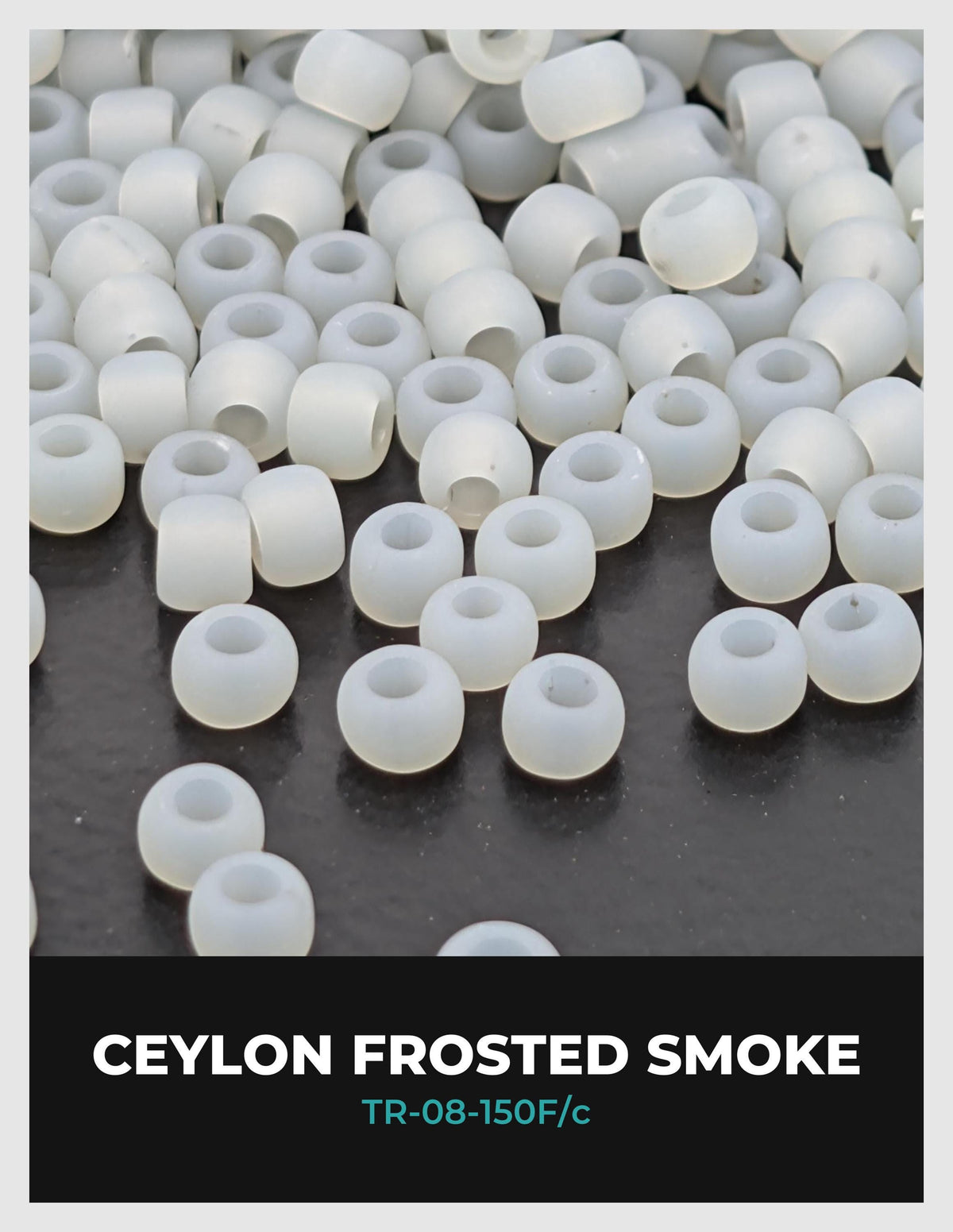 a collection of white, frosted smoke beads scattered on a dark surface.